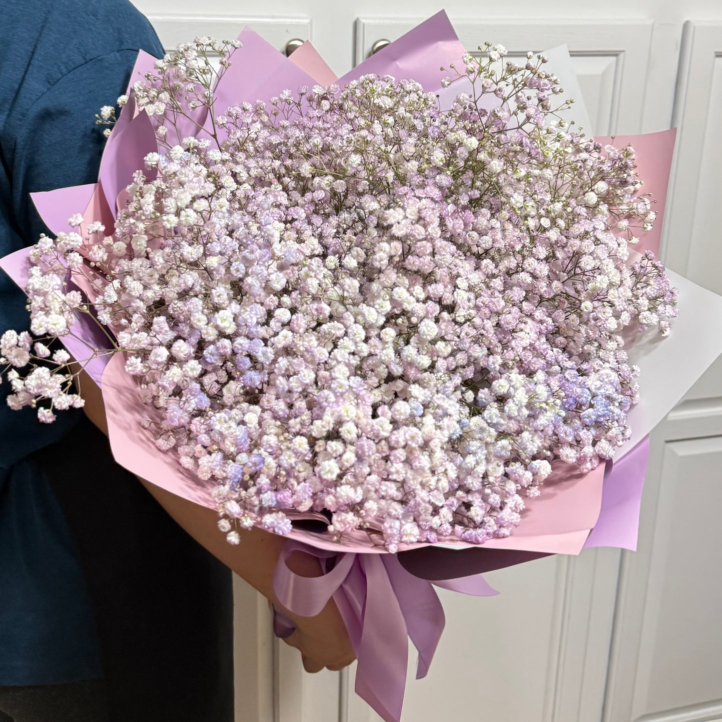 Large bouquet of delicate pink and purple baby's breath flowers.